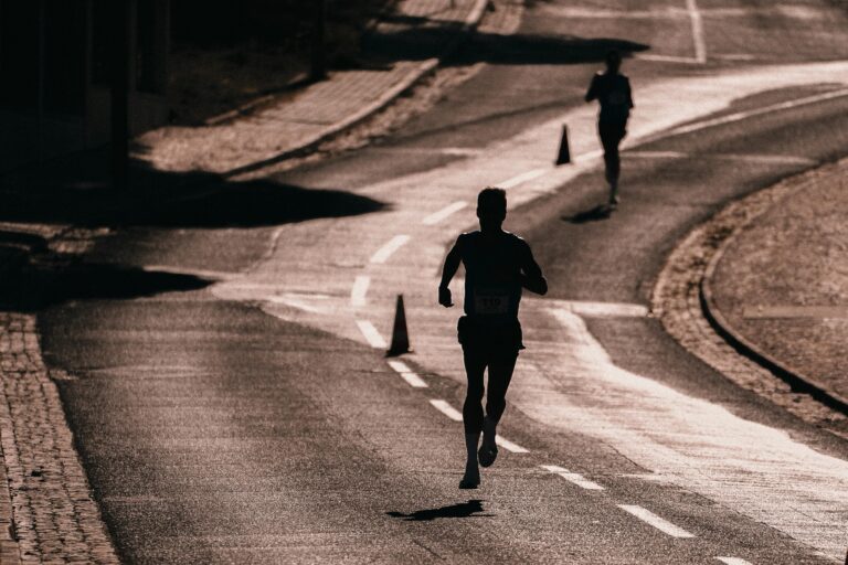 Silhouette of a man running on the street